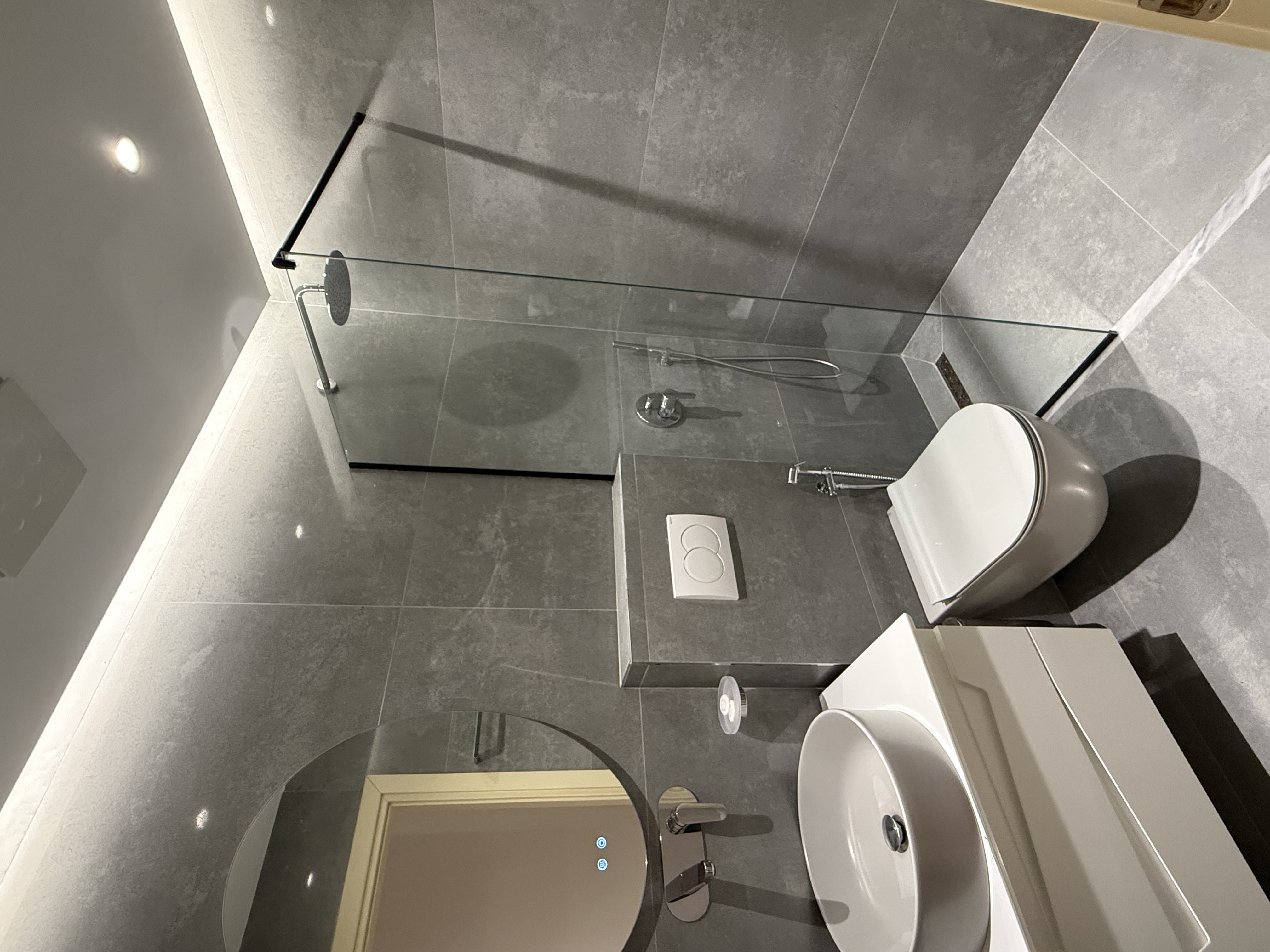 Luxury bathroom with walk-in shower at GM Residence